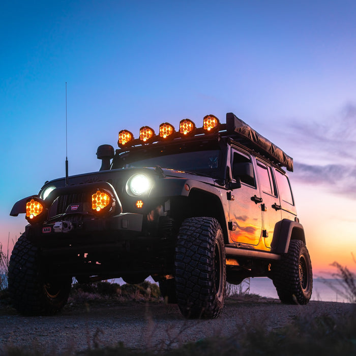 Jeep with overlanding gear in front of sunset